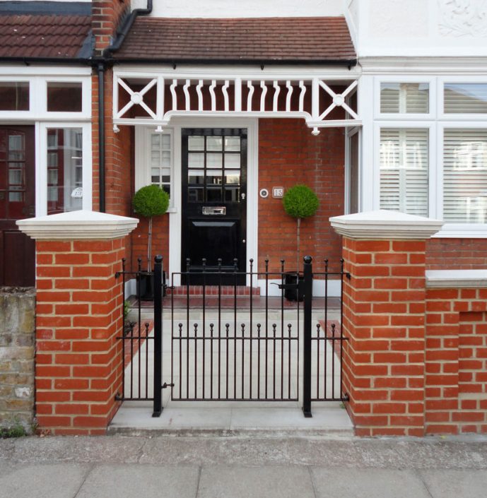 Iron gate with matching glossy black front door